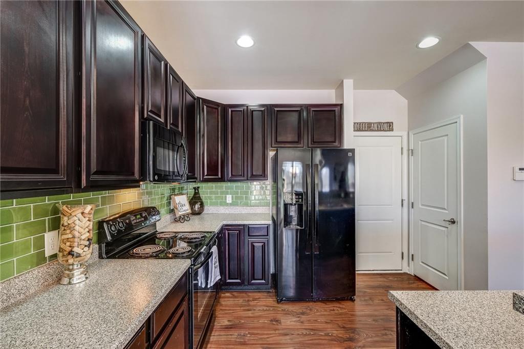 Doors off the Kitchen go to the two car Garage or down to the Finished Basement