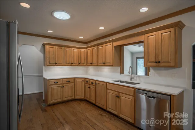 a kitchen with stainless steel appliances a sink stove and cabinets