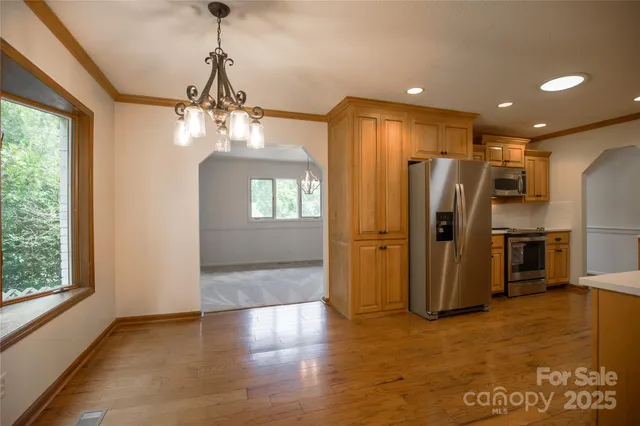 a front view of house with yard and trees around