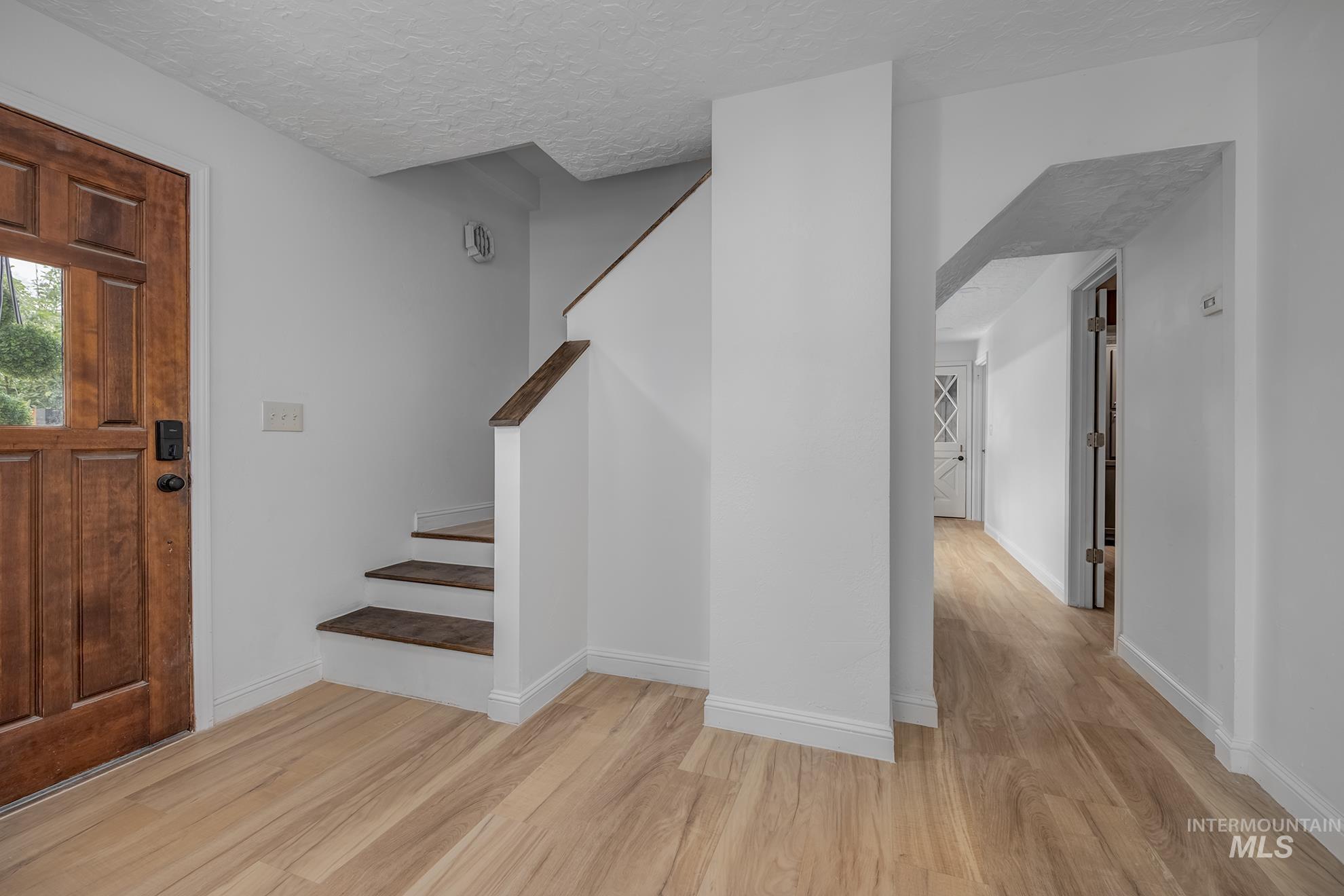 61 Southwest 4th Street Ontario, OR 97914 - Photo 4 of 42 Warm wood-finish flooring complements the solid wood entry door