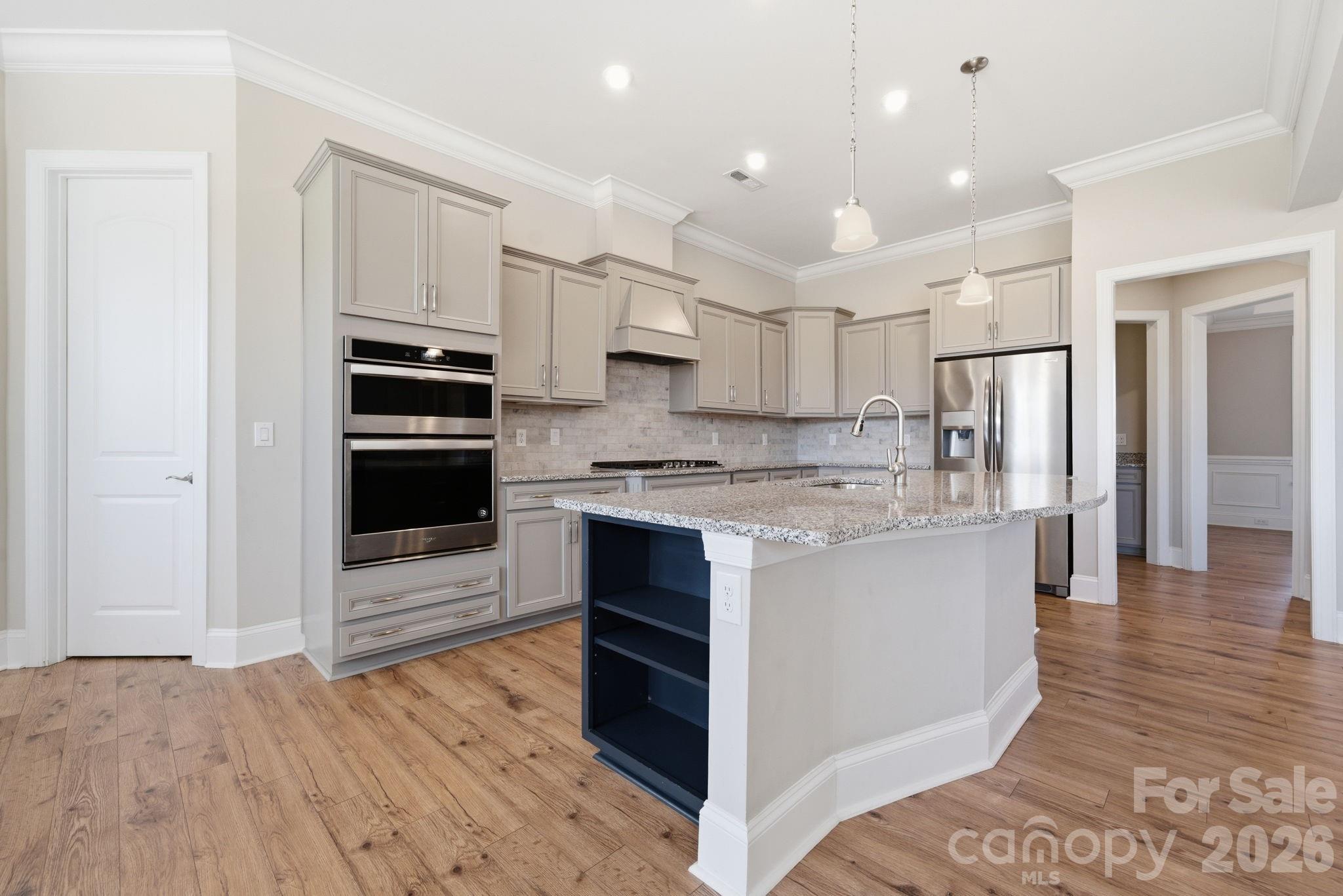 8920 Branch Brook Place Huntersville, NC 28078 - Photo 12 of 41 a kitchen with stainless steel appliances granite countertop a refrigerator and a stove top oven