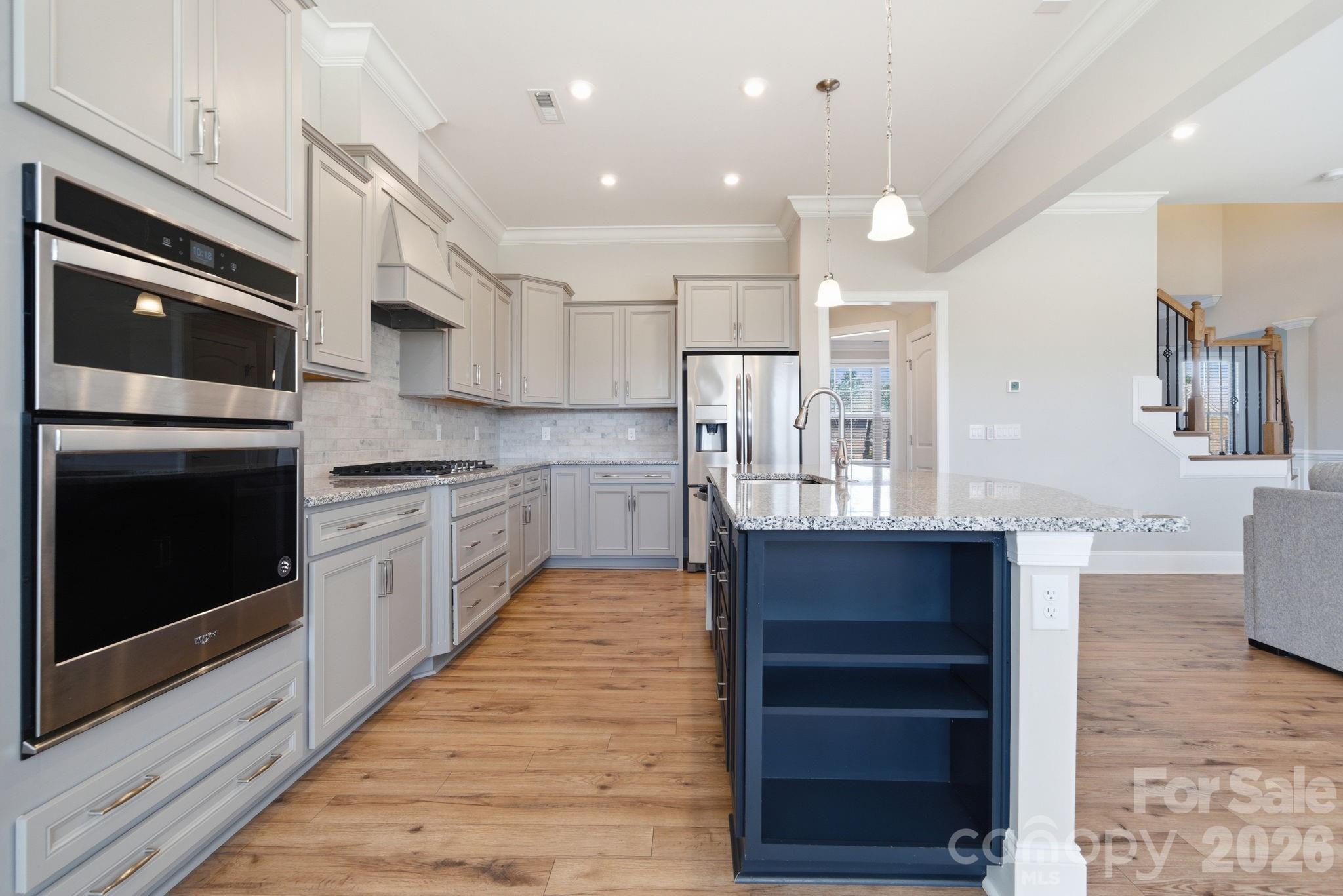 8920 Branch Brook Place Huntersville, NC 28078 - Photo 14 of 41 a kitchen with stainless steel appliances kitchen island granite countertop a stove and a refrigerator
