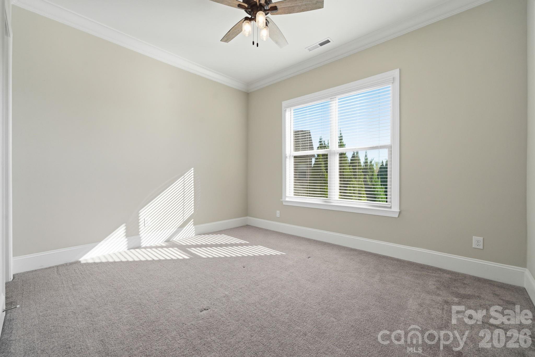 8920 Branch Brook Place Huntersville, NC 28078 - Photo 18 of 41 an empty room with a window and a ceiling fan