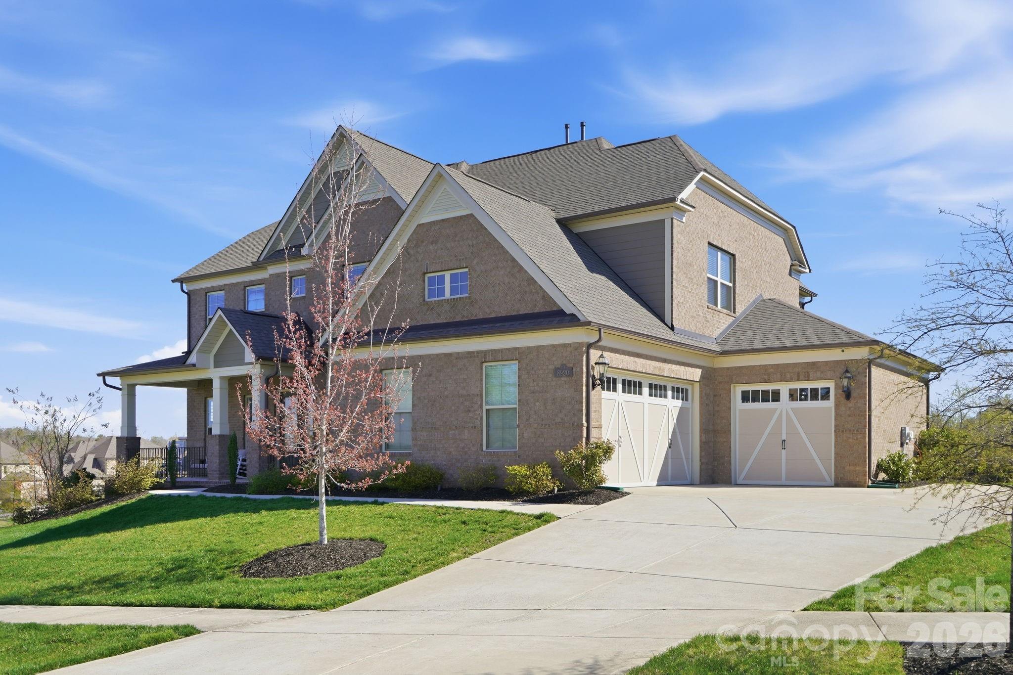 8920 Branch Brook Place Huntersville, NC 28078 - Photo 2 of 41 a front view of a house with a garden