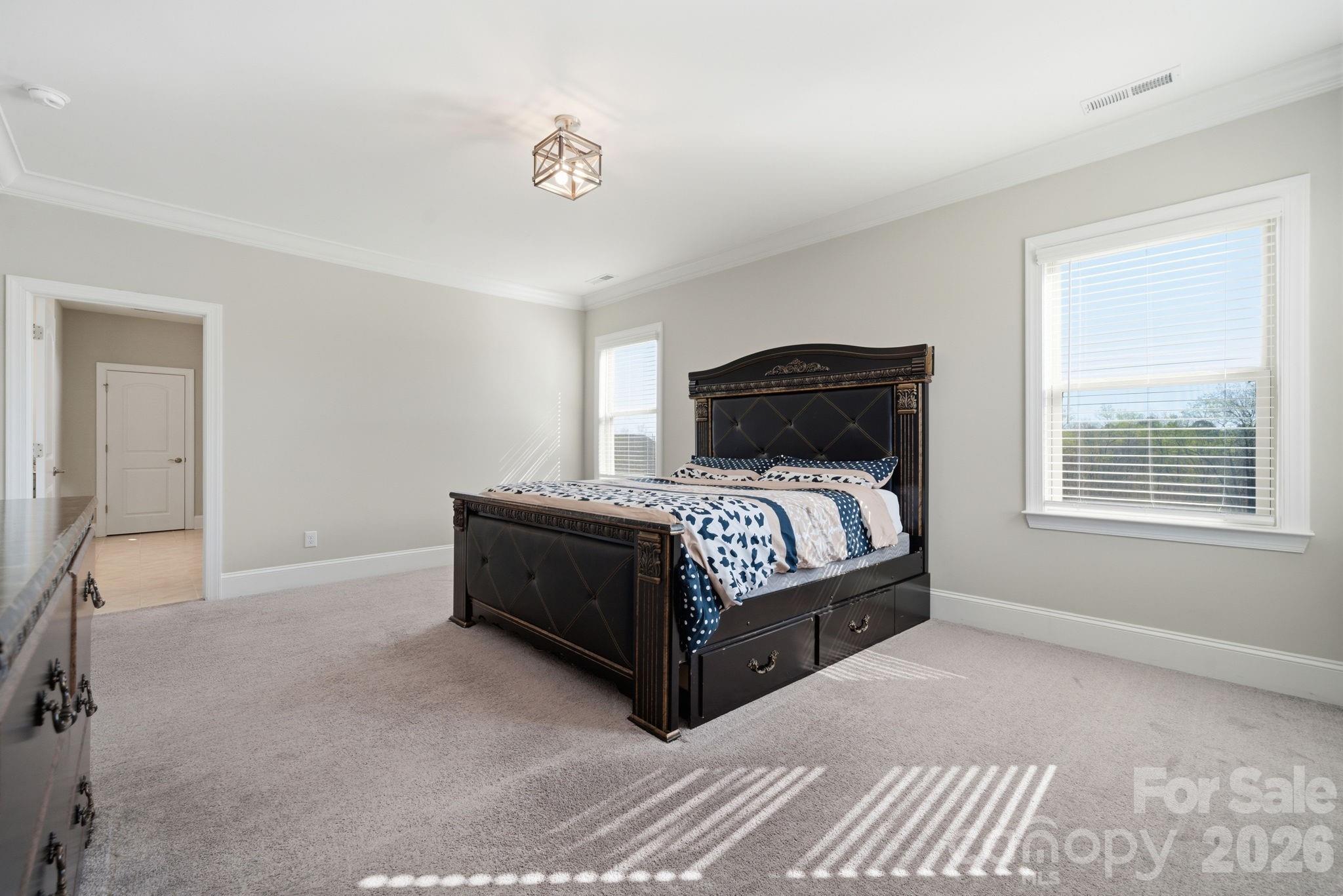 8920 Branch Brook Place Huntersville, NC 28078 - Photo 25 of 41 a bed sitting in a bedroom next to a window