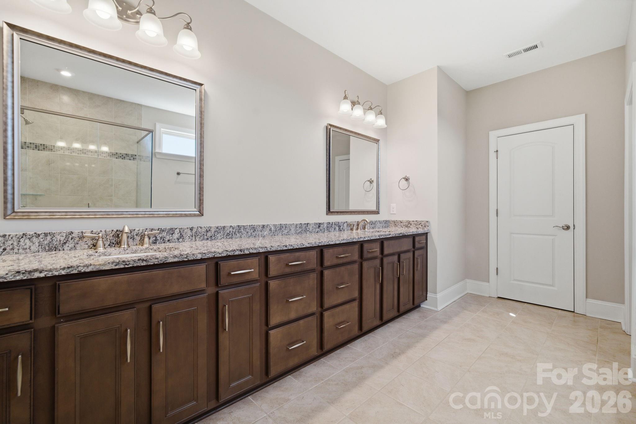 8920 Branch Brook Place Huntersville, NC 28078 - Photo 27 of 41 a bathroom with a granite countertop double vanity sink and a mirror