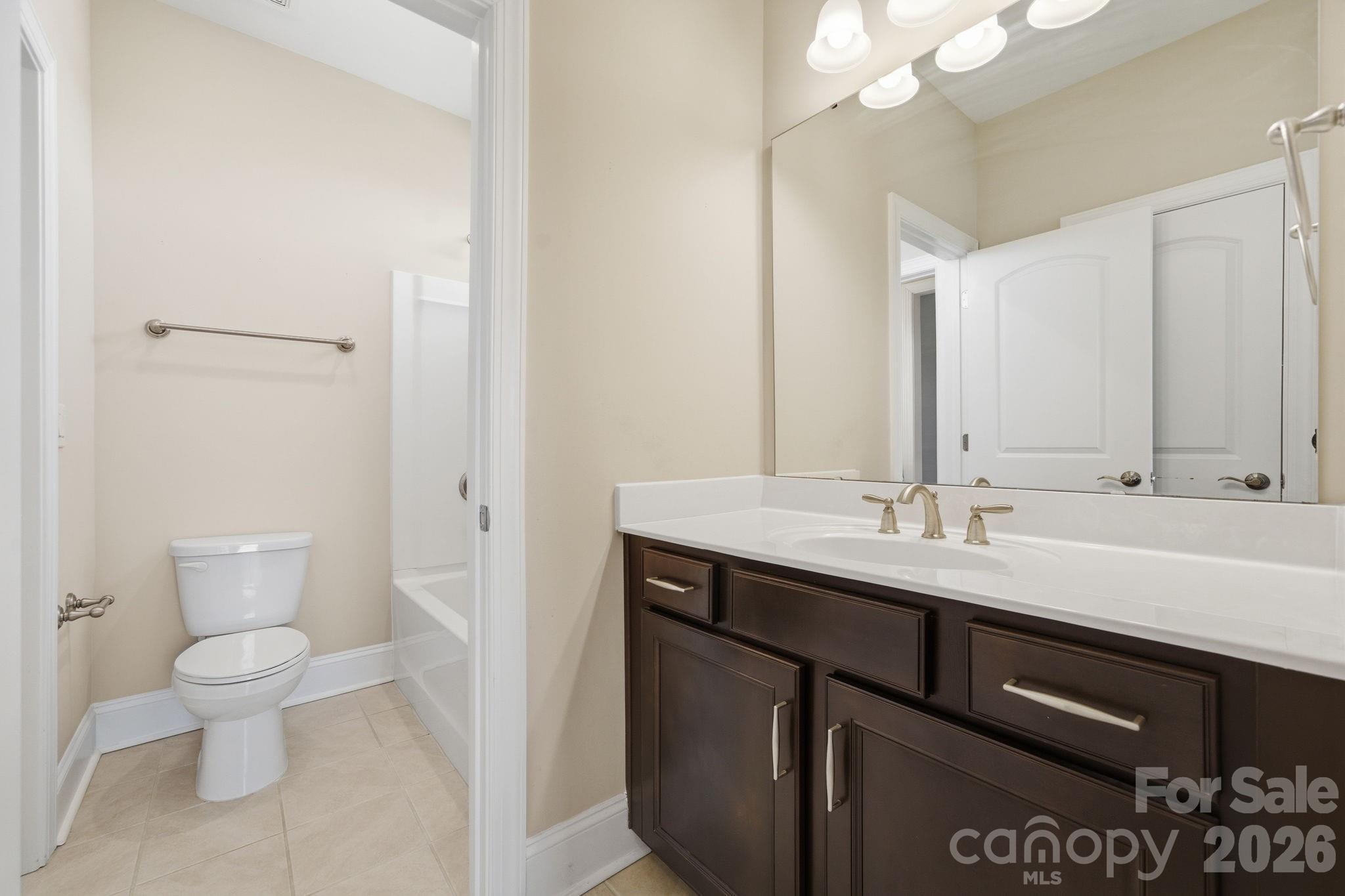 8920 Branch Brook Place Huntersville, NC 28078 - Photo 30 of 41 a bathroom with a sink a toilet and a mirror