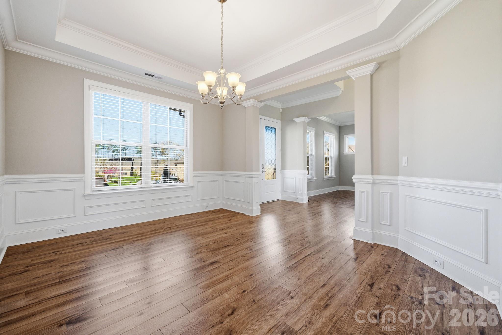 8920 Branch Brook Place Huntersville, NC 28078 - Photo 6 of 41 a view of an empty room with wooden floor and a window