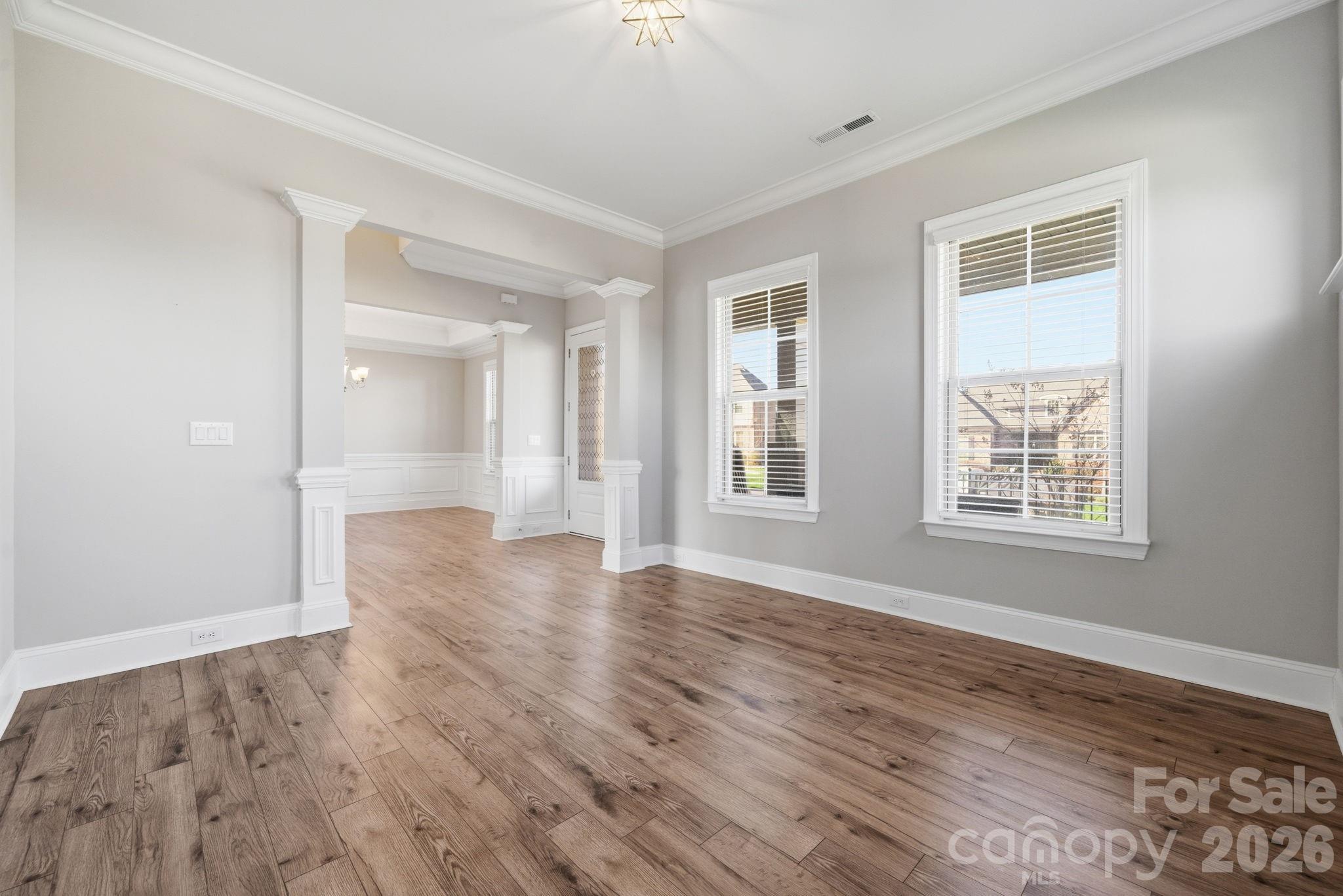 8920 Branch Brook Place Huntersville, NC 28078 - Photo 8 of 41 a view of an empty room with wooden floor and a window