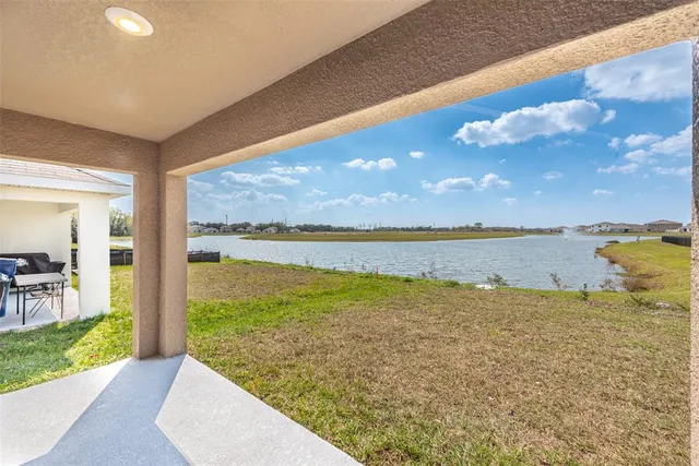 an aerial view of residential houses with outdoor space and parking