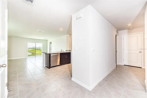 a kitchen with kitchen island a counter top space cabinets and stainless steel appliances