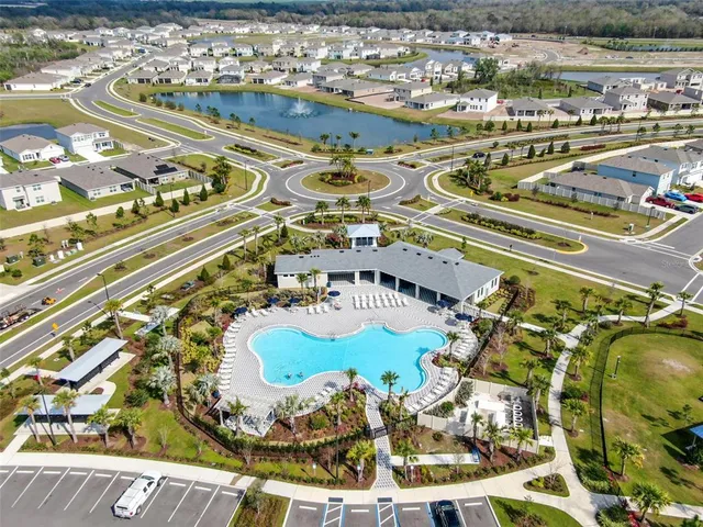 a view of a swimming pool with a table and chairs