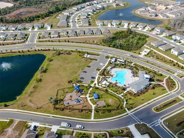a swimming pool with outdoor seating and yard
