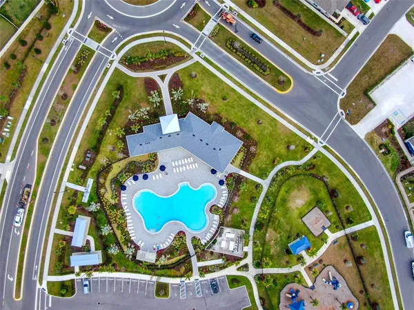 a view of a swimming pool in front of residential buildings