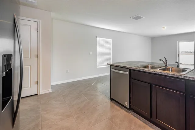 a kitchen with stainless steel appliances granite countertop a stove top oven and sink