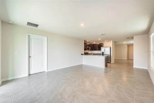 an empty room with a fireplace and a window