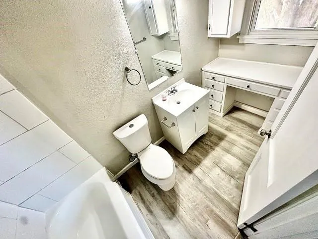 a bathroom with a sink toilet and a mirror