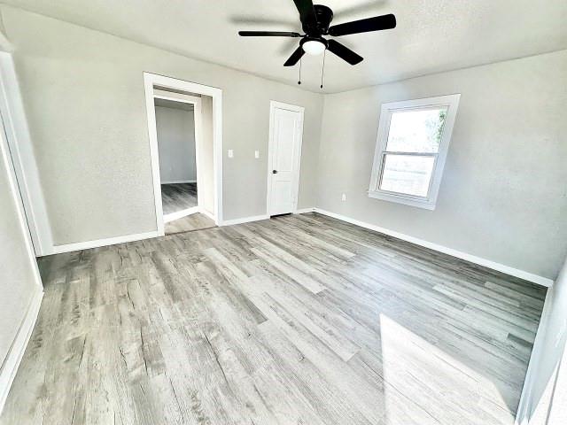 409 SW Avenue East Seminole, TX 79360 - Photo 13 of 16 a view of empty room with wooden floor and fan