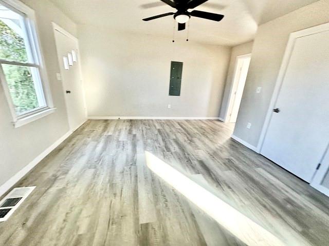 409 SW Avenue East Seminole, TX 79360 - Photo 9 of 16 wooden floor in an empty room with a window