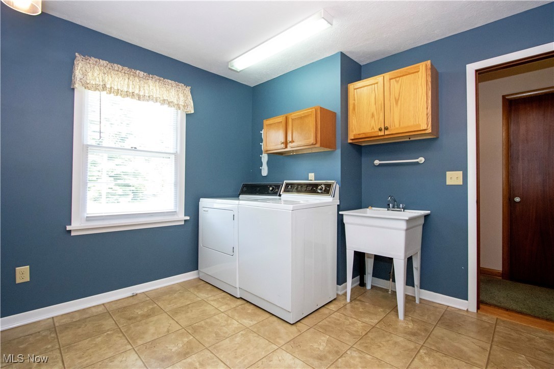 2456 Batdorf Road Wooster, OH 44691 - Photo 16 of 22 Laundry room with cabinet space, washing machine and dryer, and light tile patterned floors