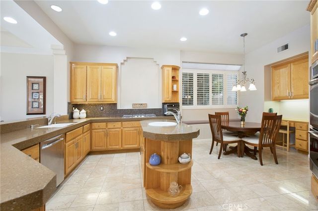 a large kitchen with kitchen island a large window in it