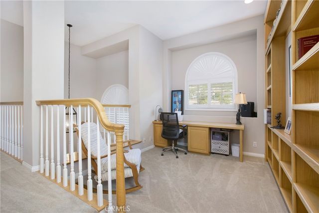 a bathroom with a granite countertop shower sink and mirror