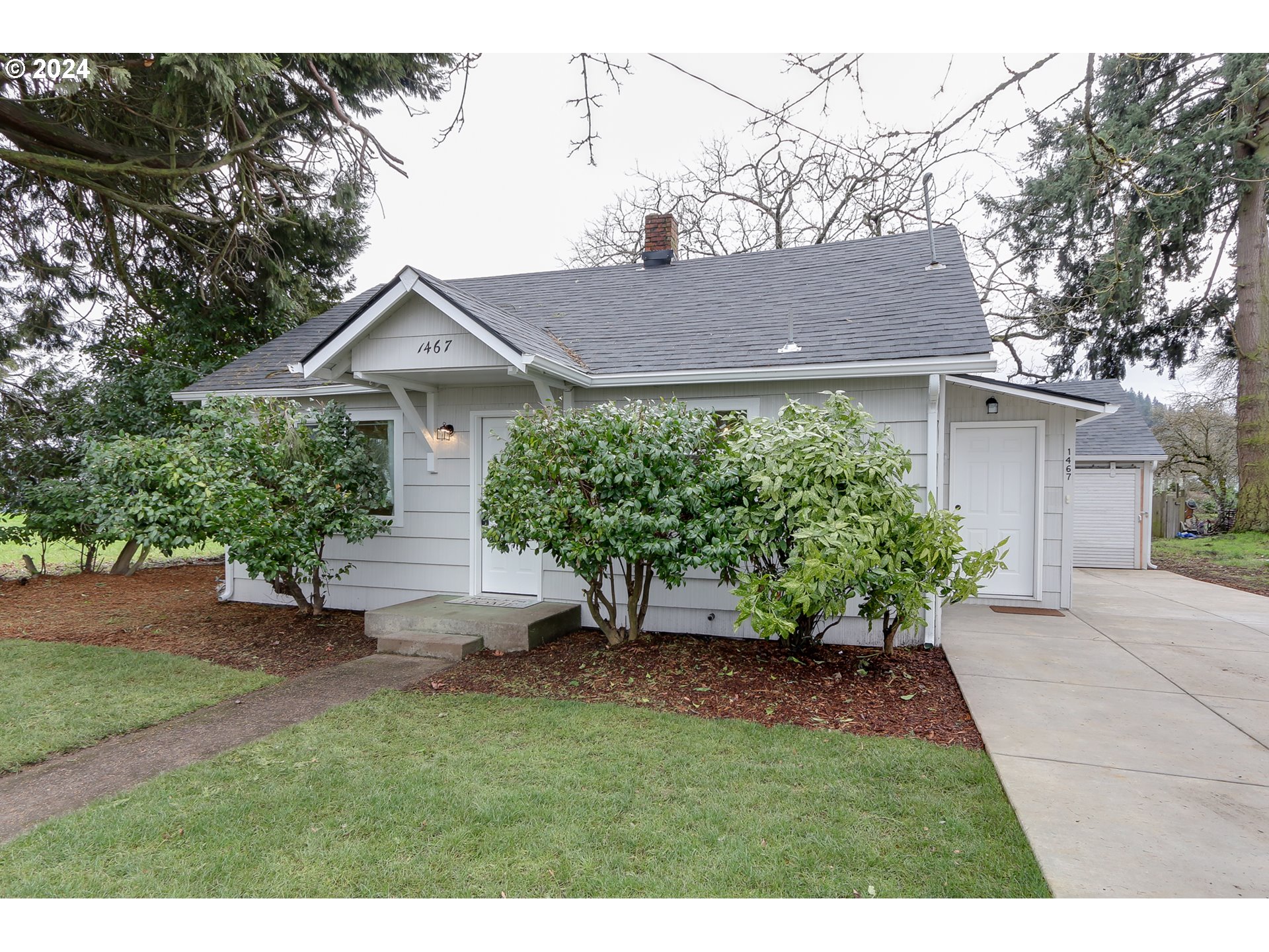 1467 Main Street Springfield, OR 97477 - Photo 1 of 29 a view of a house with a yard and potted plants