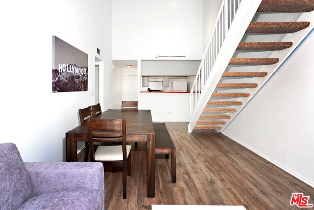 a view of a livingroom with furniture and staircase