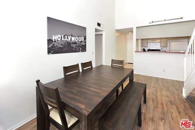 a dining room with furniture and wooden floor