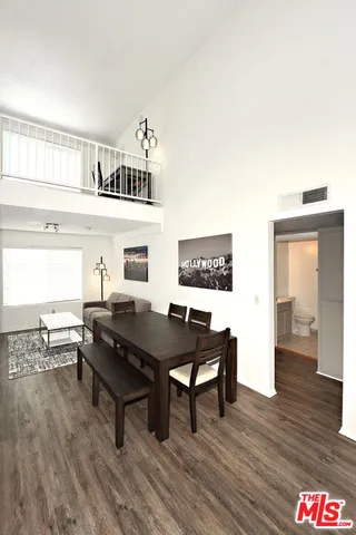a view of a workspace with furniture and wooden floor