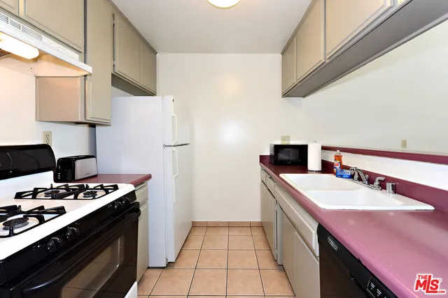 a kitchen with a sink stove and refrigerator