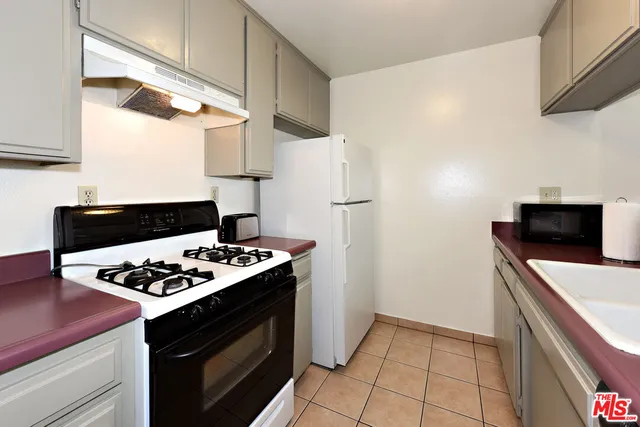 a kitchen with a stove and a refrigerator