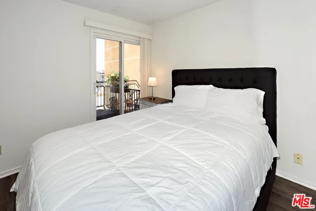 a large bed sitting in a bedroom next to a window