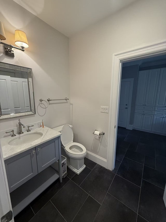 15 Cedar Road Brookline, MA 02467 - Photo 12 of 26 a bathroom with a toilet sink and mirror