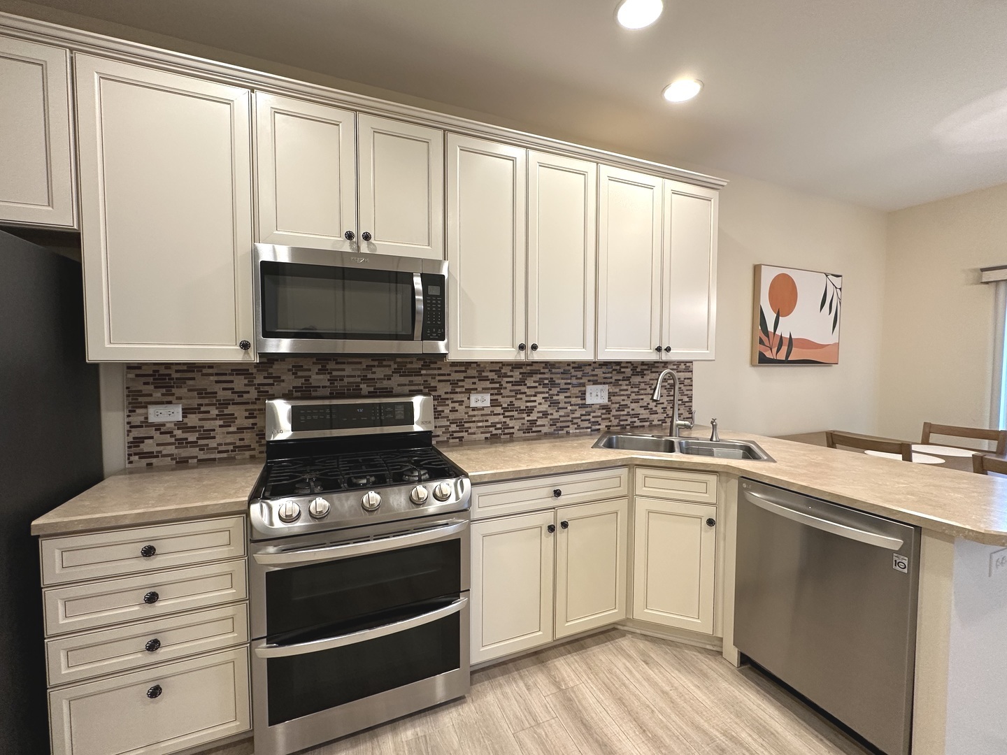 5102 Monroe Street Matteson, IL 60443 - Photo 19 of 54 a kitchen with cabinets appliances and a window