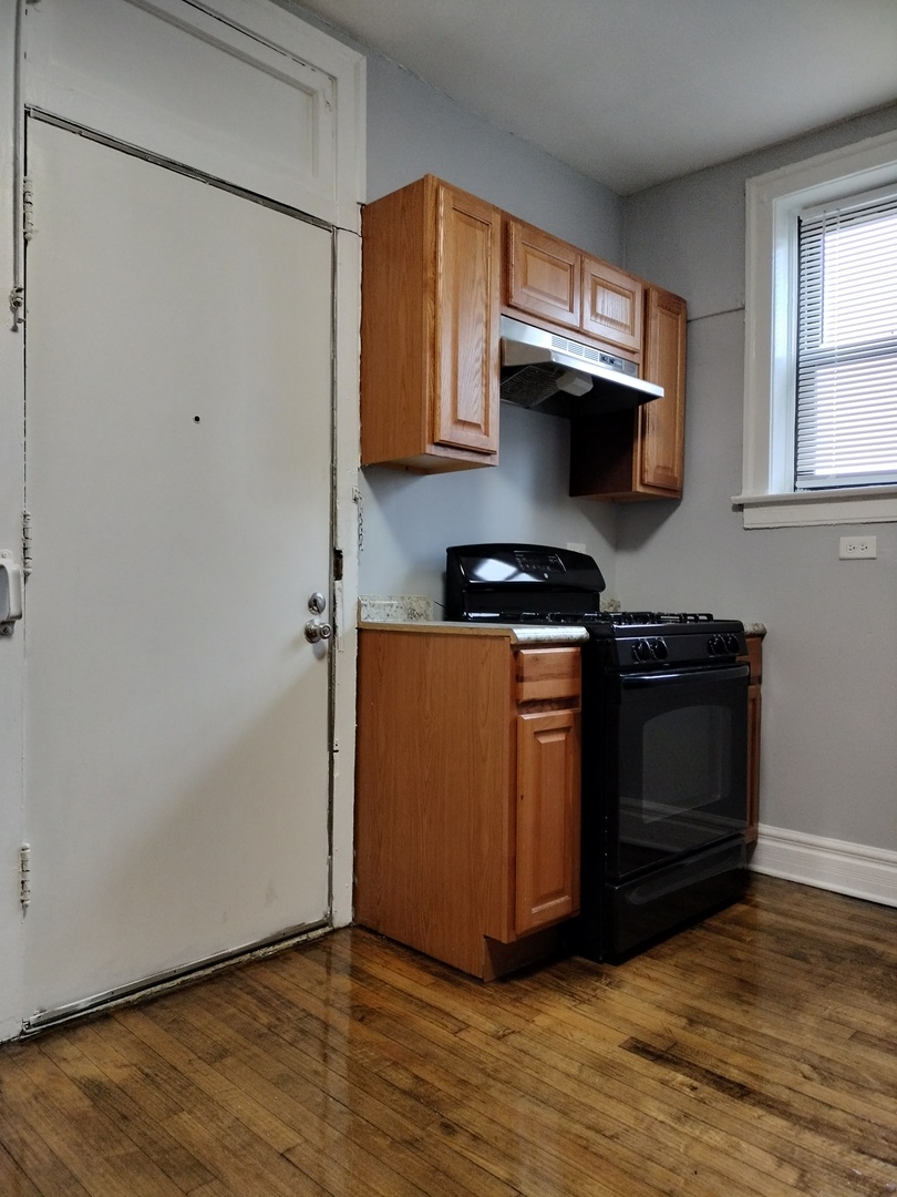 1739 West 80th Street, Unit 17933 Chicago, IL 60620 - Photo 11 of 17 a kitchen with stainless steel appliances granite countertop a stove a microwave and a refrigerator