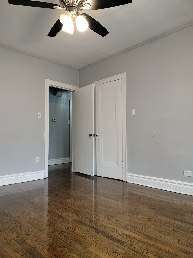 1739 West 80th Street, Unit 17933 Chicago, IL 60620 - Photo 13 of 17 an empty room with wooden floor closet and windows