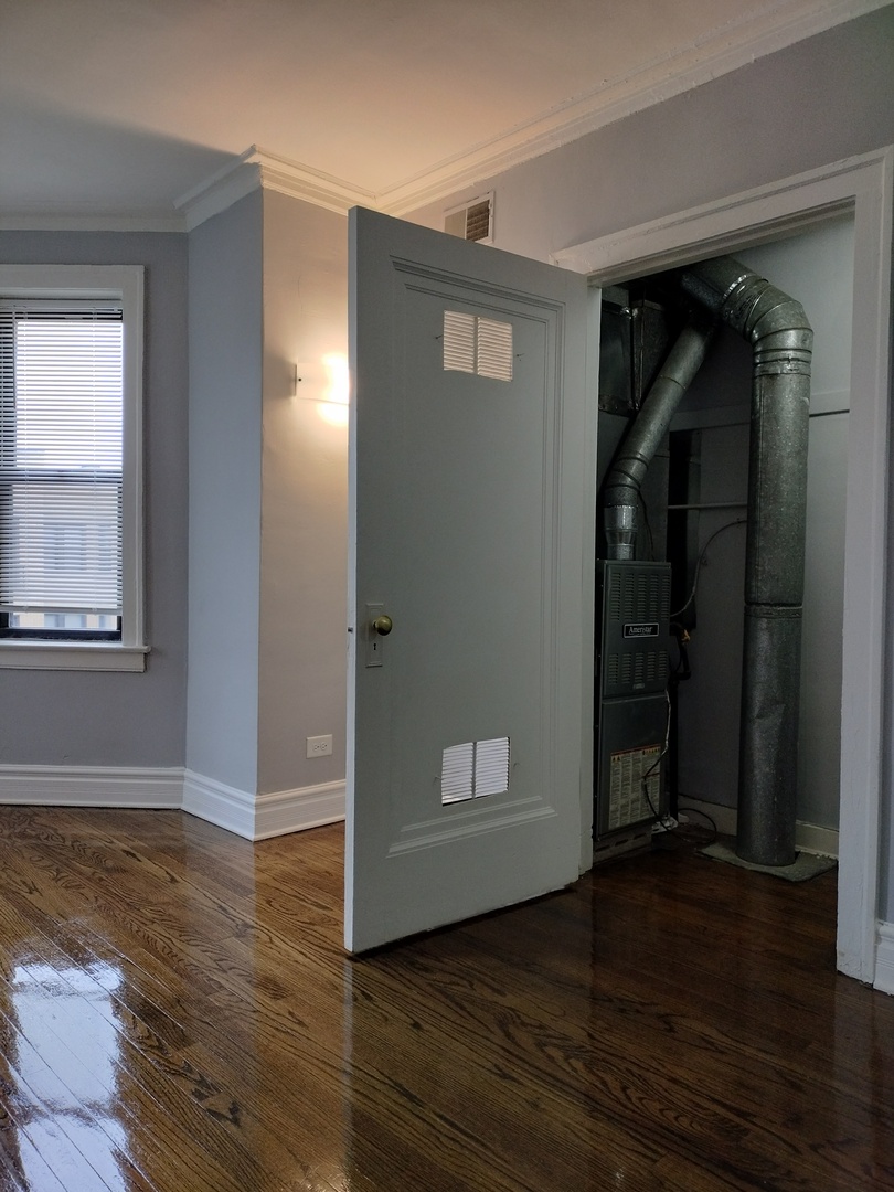 1739 West 80th Street, Unit 17933 Chicago, IL 60620 - Photo 7 of 17 a view of empty room with wooden floor and closet