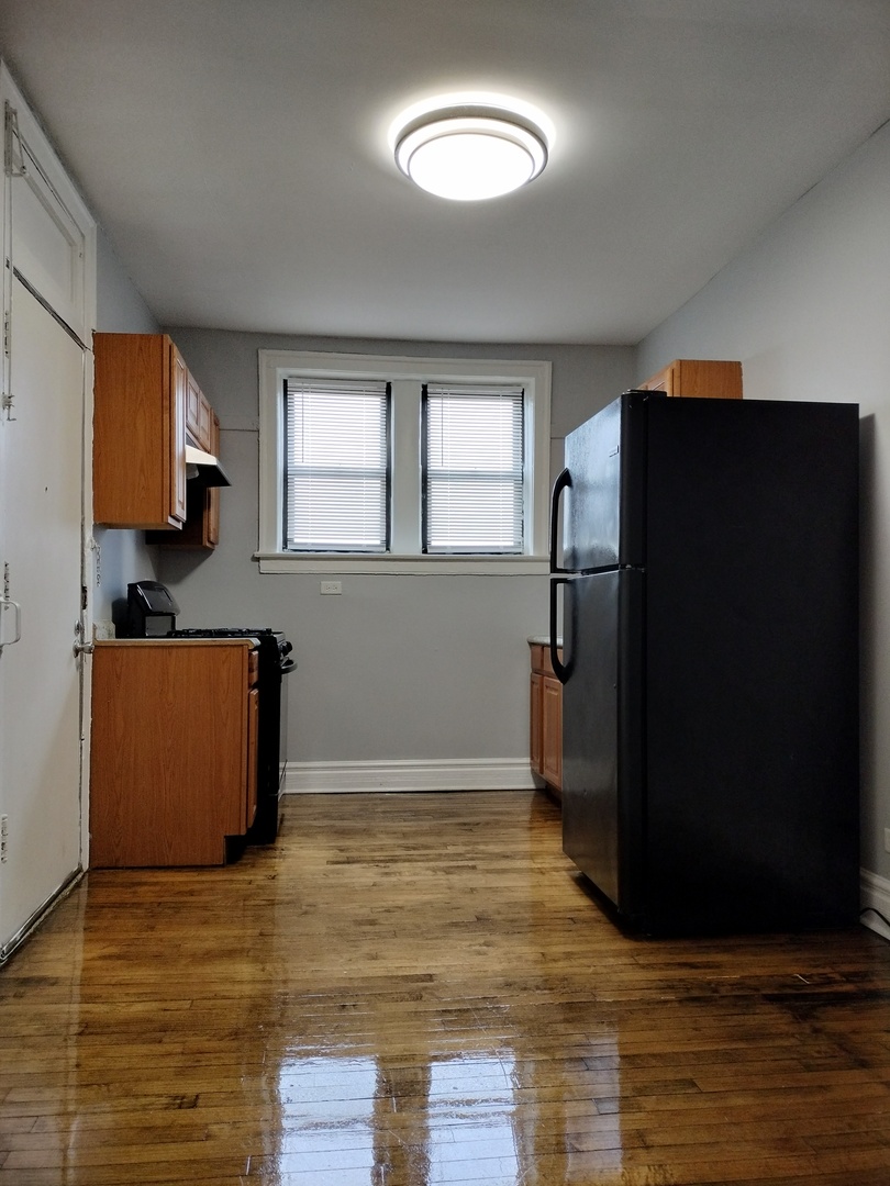 1739 West 80th Street, Unit 17933 Chicago, IL 60620 - Photo 9 of 17 a kitchen with granite countertop a refrigerator and a stove top oven