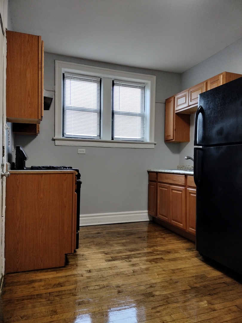 1739 West 80th Street, Unit 17933 Chicago, IL 60620 - Photo 10 of 17 a kitchen with stainless steel appliances granite countertop a refrigerator and a sink
