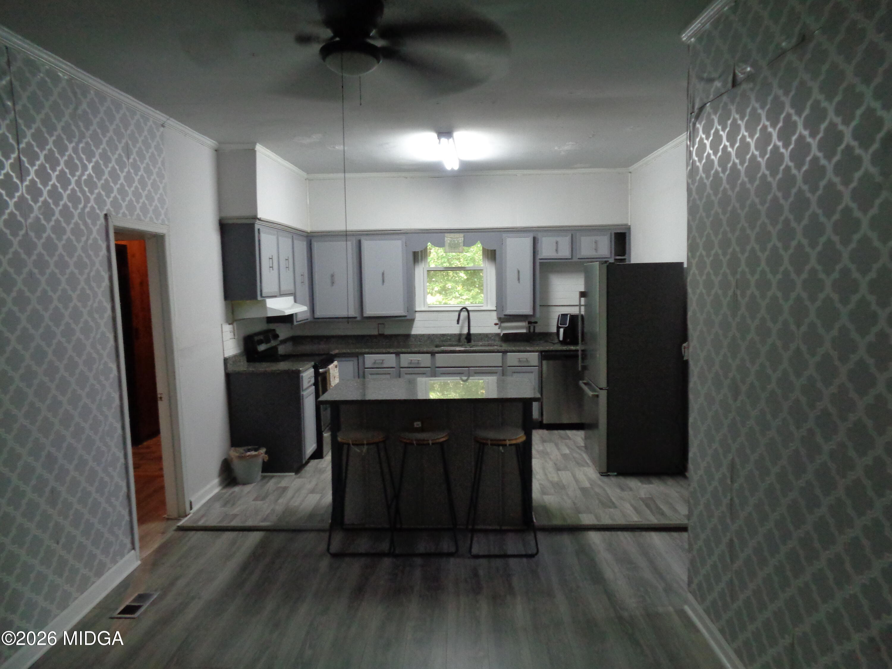 3380 Goodwin Lane Macon, GA 31217 - Photo 7 of 22 a kitchen with refrigerator cabinets and wooden floor