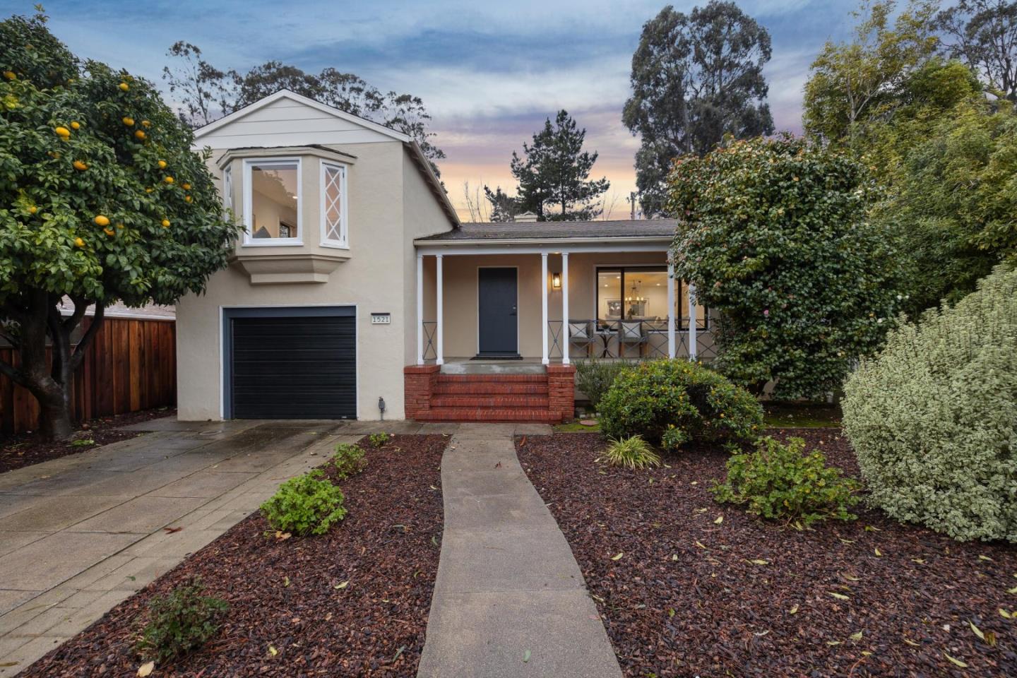 a front view of a house with a garden