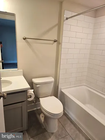 a white toilet sitting next to a bath tub