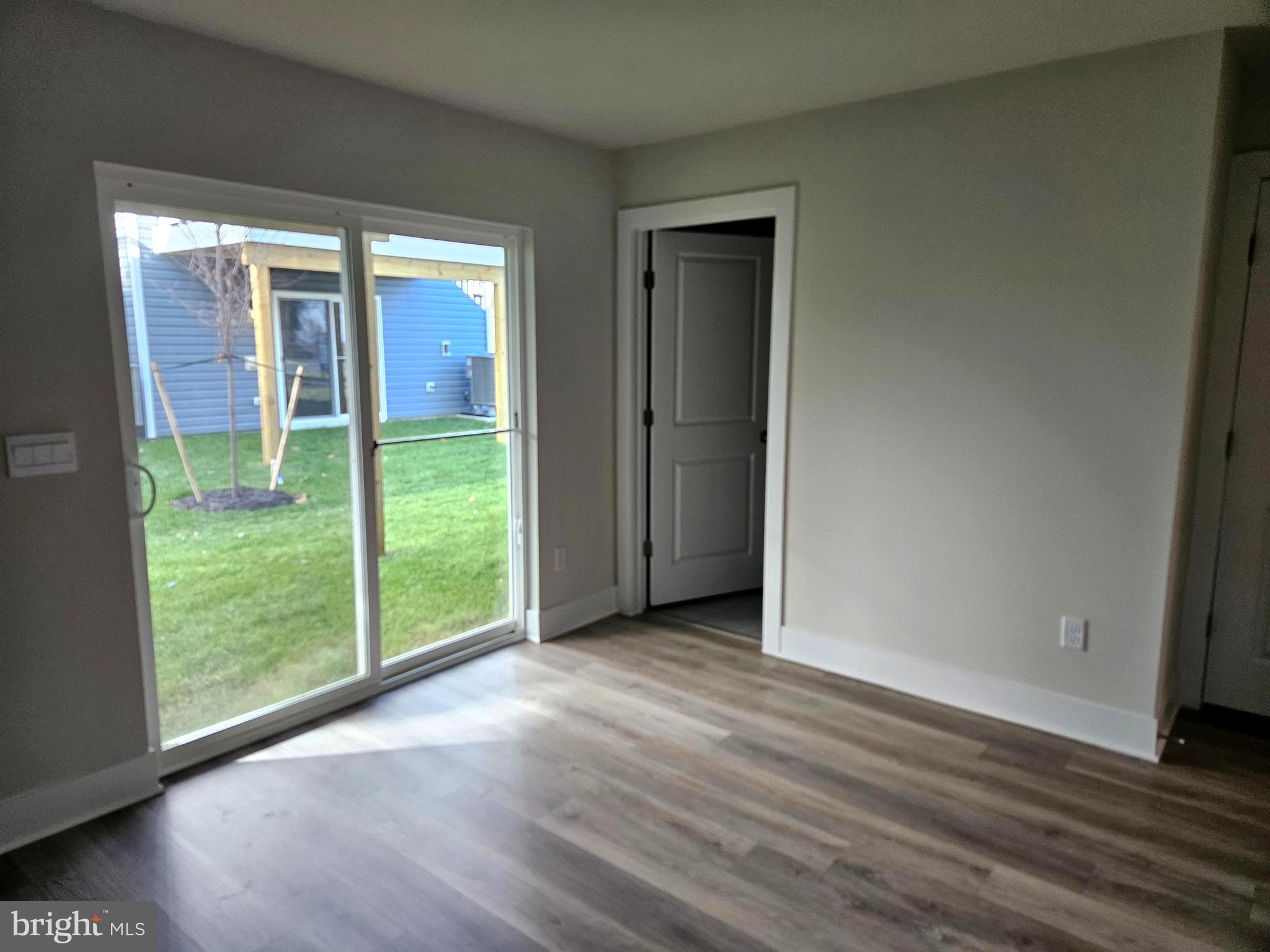 1815 Reese Court Winchester, VA 22601 - Photo 6 of 14 a view of an empty room with wooden floor and a window