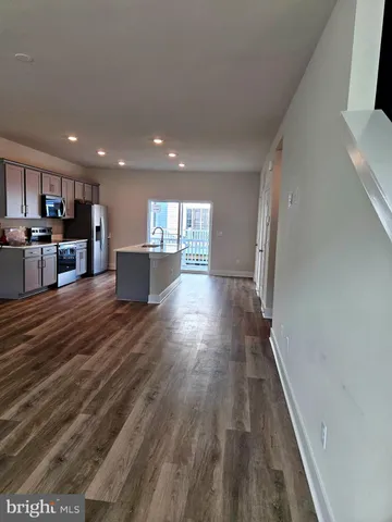 a view of a kitchen with wooden floor