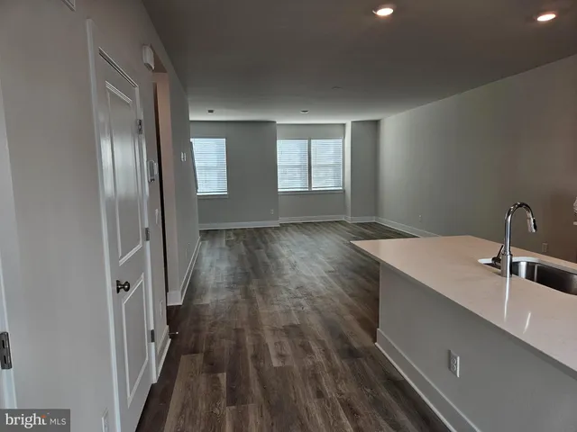 a view of a kitchen from a hallway