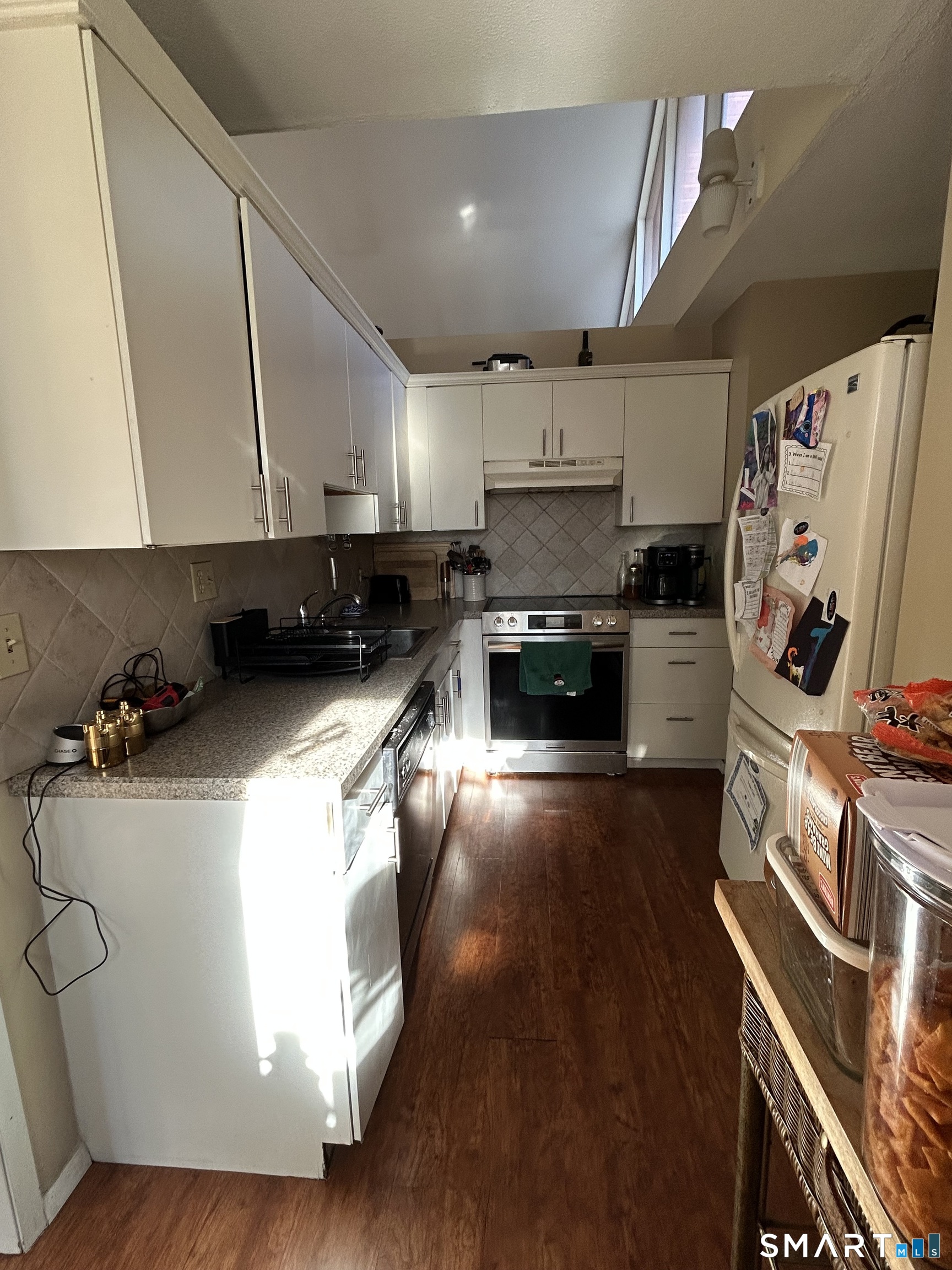 126 Sherman Hill Road, Unit B12 Woodbury, CT 06798 - Photo 20 of 27 a kitchen with stainless steel appliances a stove a sink and a refrigerator