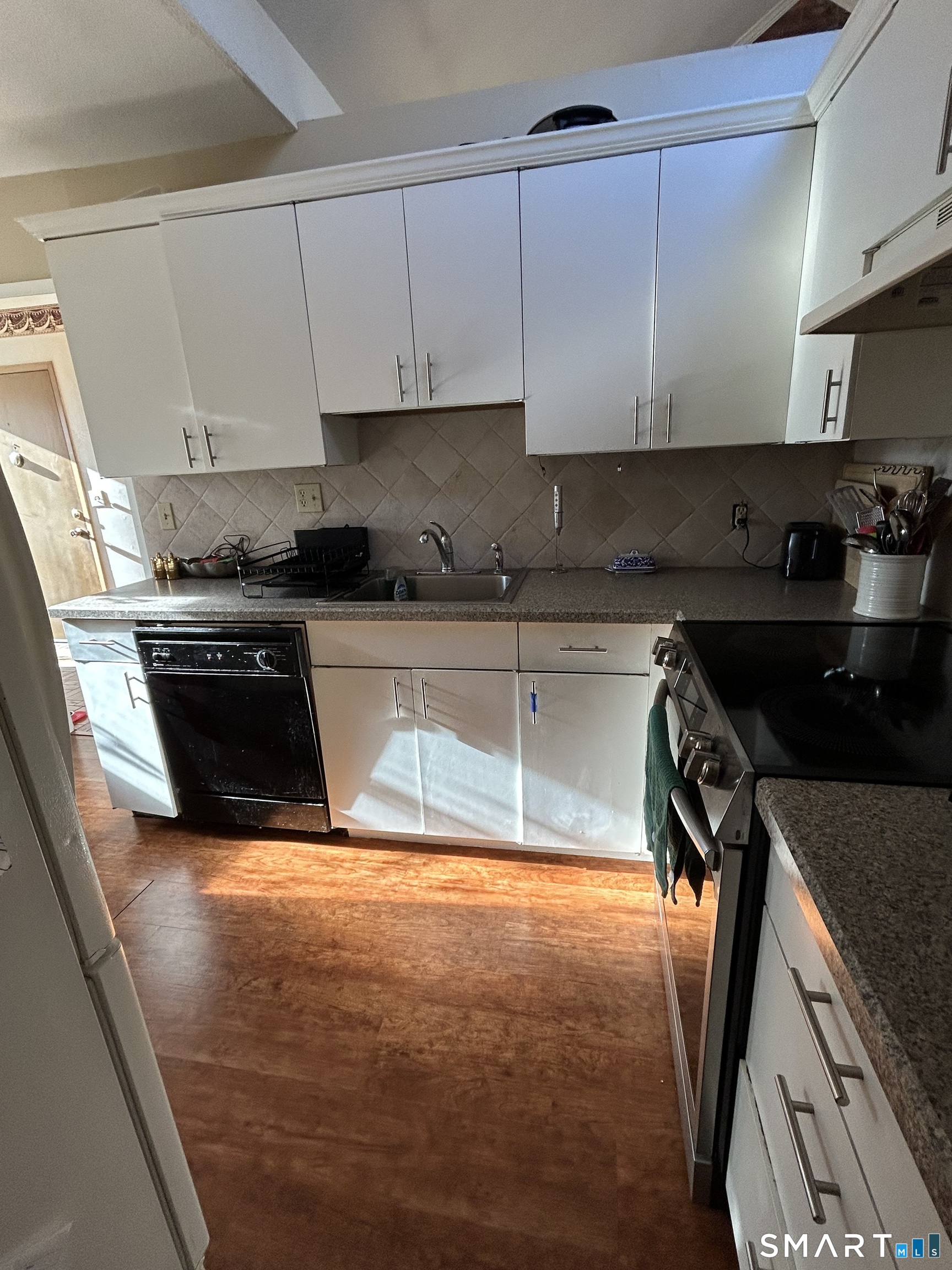 126 Sherman Hill Road, Unit B12 Woodbury, CT 06798 - Photo 22 of 27 a kitchen with stainless steel appliances granite countertop a sink a stove and a refrigerator