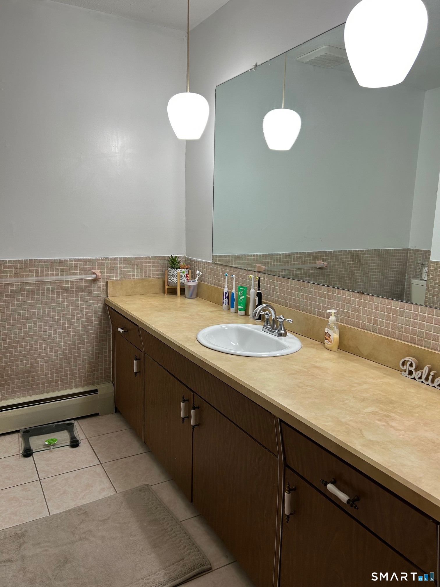 126 Sherman Hill Road, Unit B12 Woodbury, CT 06798 - Photo 26 of 27 a bathroom with a sink vanity and mirror