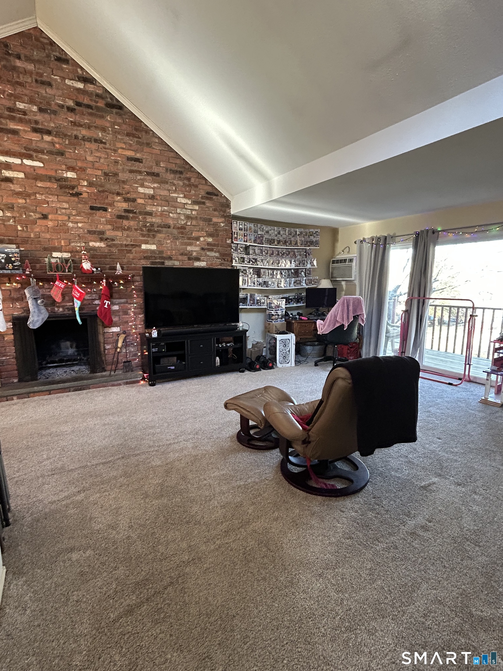 126 Sherman Hill Road, Unit B12 Woodbury, CT 06798 - Photo 10 of 27 a living room with furniture a flat screen tv and a fireplace